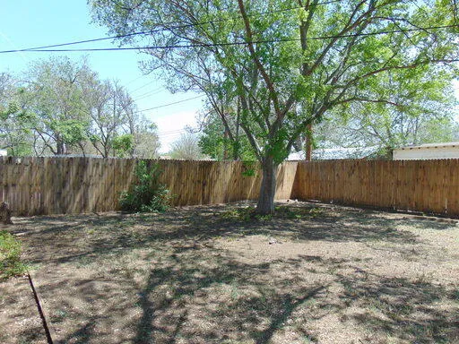 a view of outdoor space with wooden fence