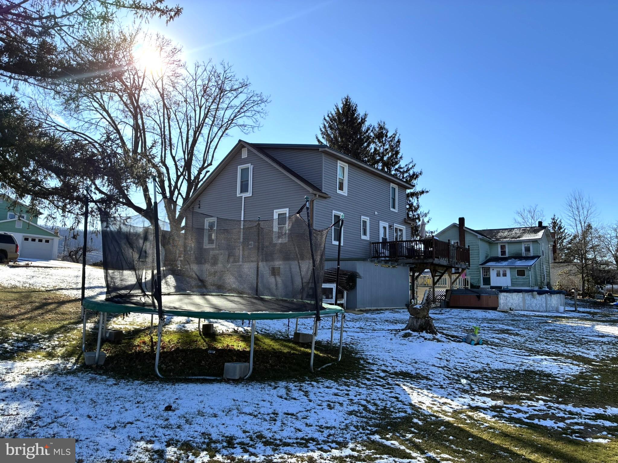 421 James Street Lock Haven, PA 17745 - Photo 29 of 39 Sunny backyard with a trampoline and snow.