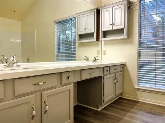 a bathroom with a double vanity sink and a mirror