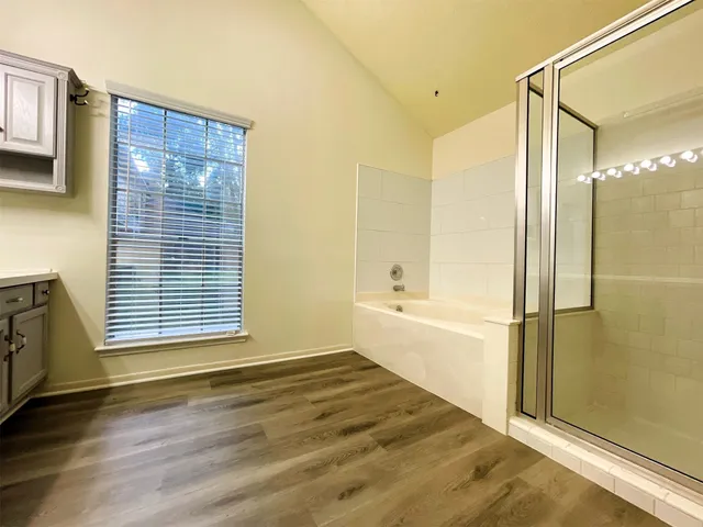 a spacious bathroom with a bathtub and a shower