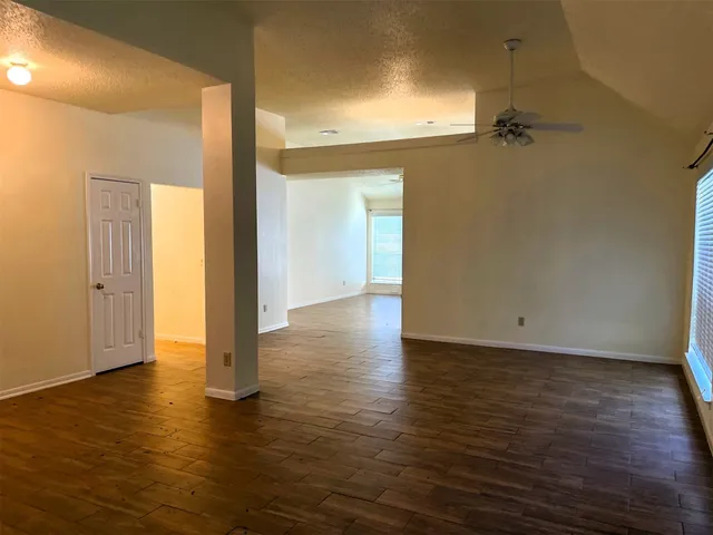 a view of a room with wooden floor