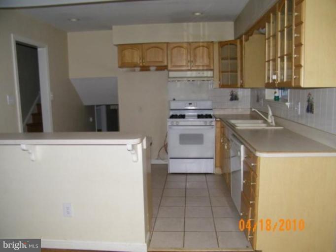 5211 Dalton Road Springfield, VA 22151 - Photo 8 of 14 a kitchen with a sink a stove and cabinets