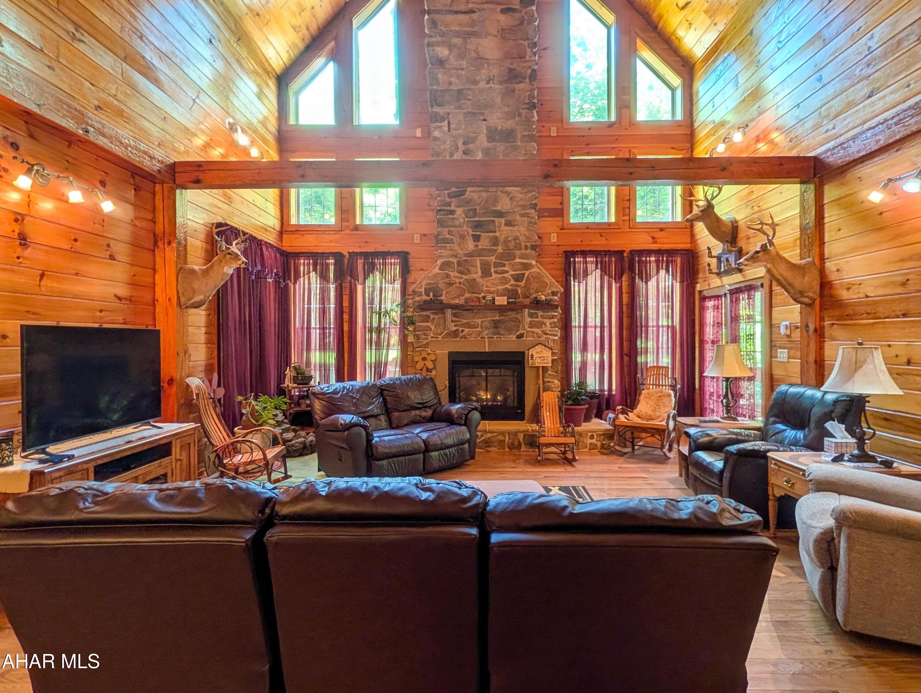 213 Sherman Valley Road Hopewell, PA 16650 - Photo 20 of 104 a living room with fireplace furniture and a flat screen tv