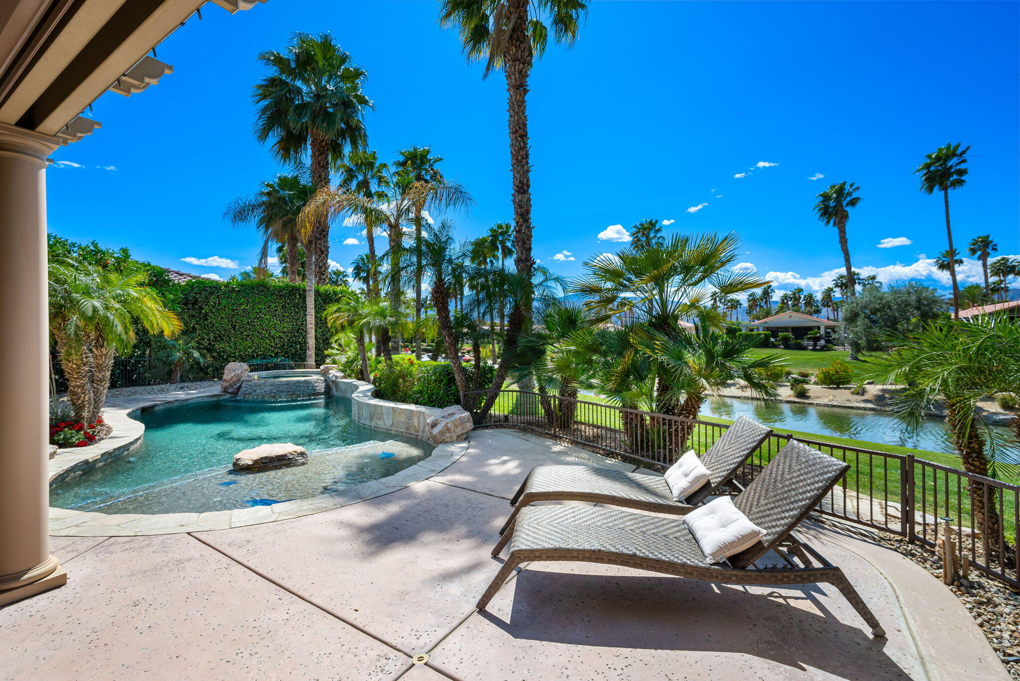 48170 Hjorth Street, Unit 74 Indio, CA 92201 - Photo 14 of 37 a view of a patio with table and chairs potted plants with wooden fence