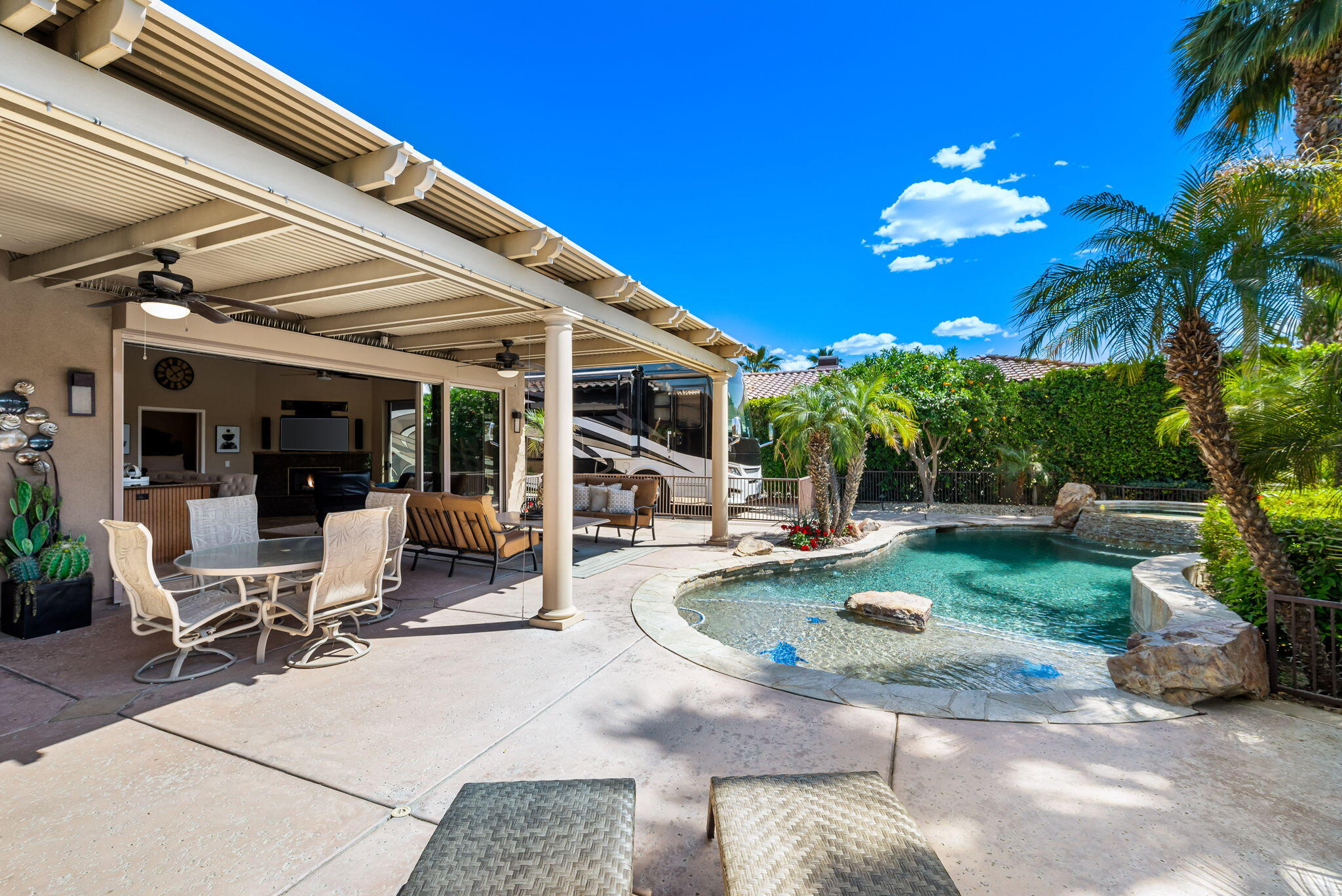 48170 Hjorth Street, Unit 74 Indio, CA 92201 - Photo 15 of 37 a view of a house with backyard porch and sitting area