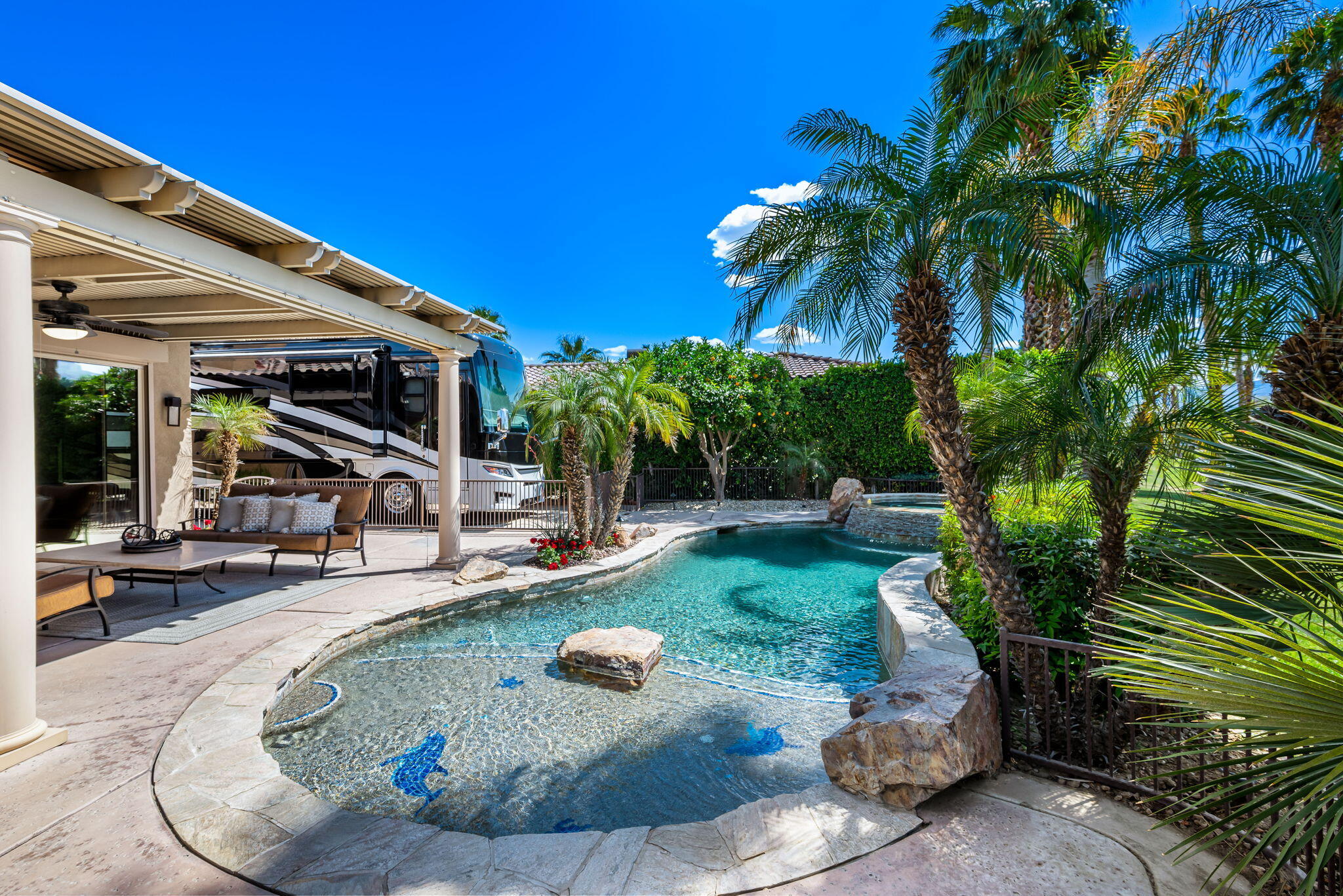 48170 Hjorth Street, Unit 74 Indio, CA 92201 - Photo 17 of 37 a view of a backyard with plants and a patio