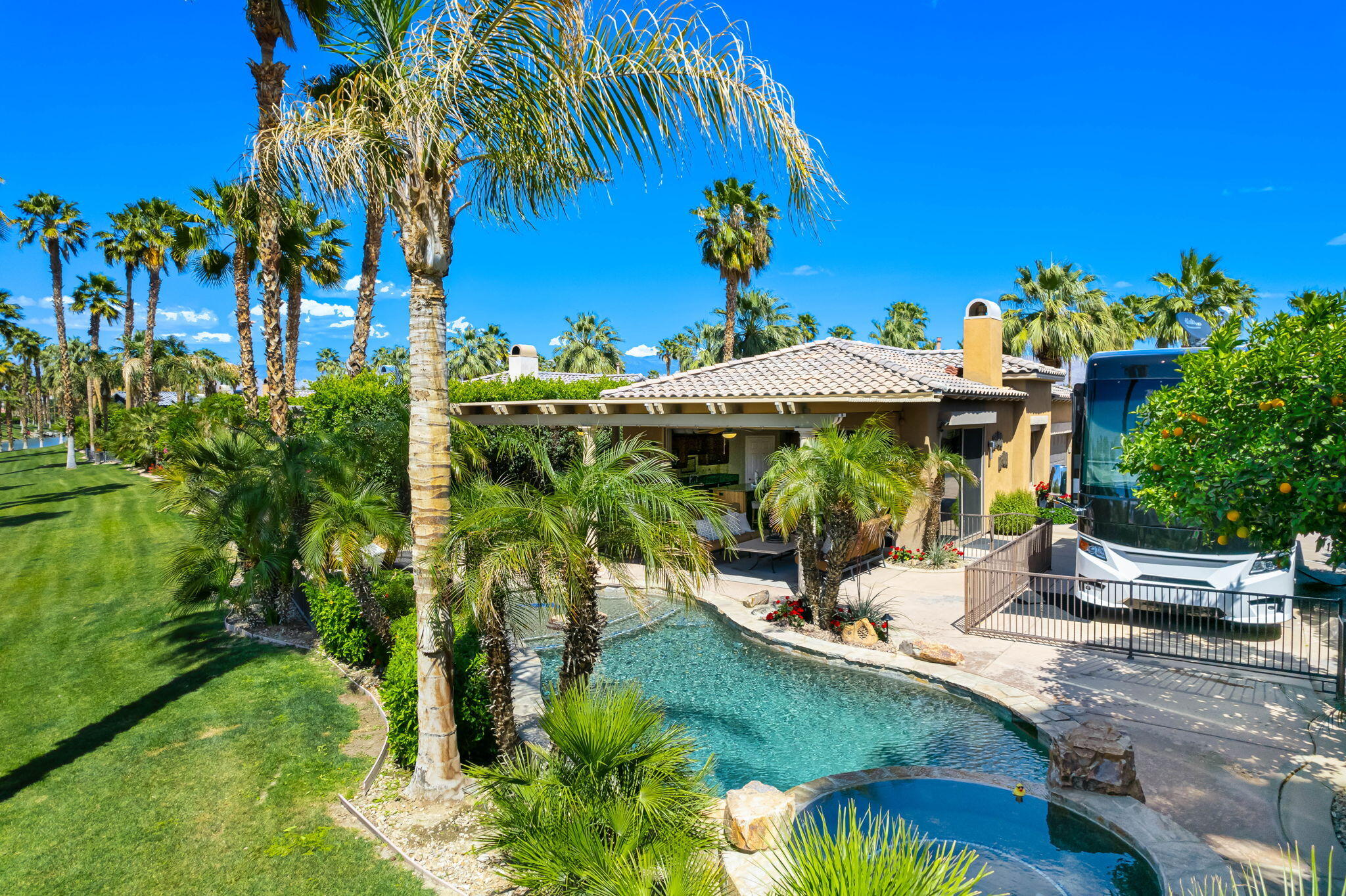 48170 Hjorth Street, Unit 74 Indio, CA 92201 - Photo 2 of 37 a view of a swimming pool with a patio