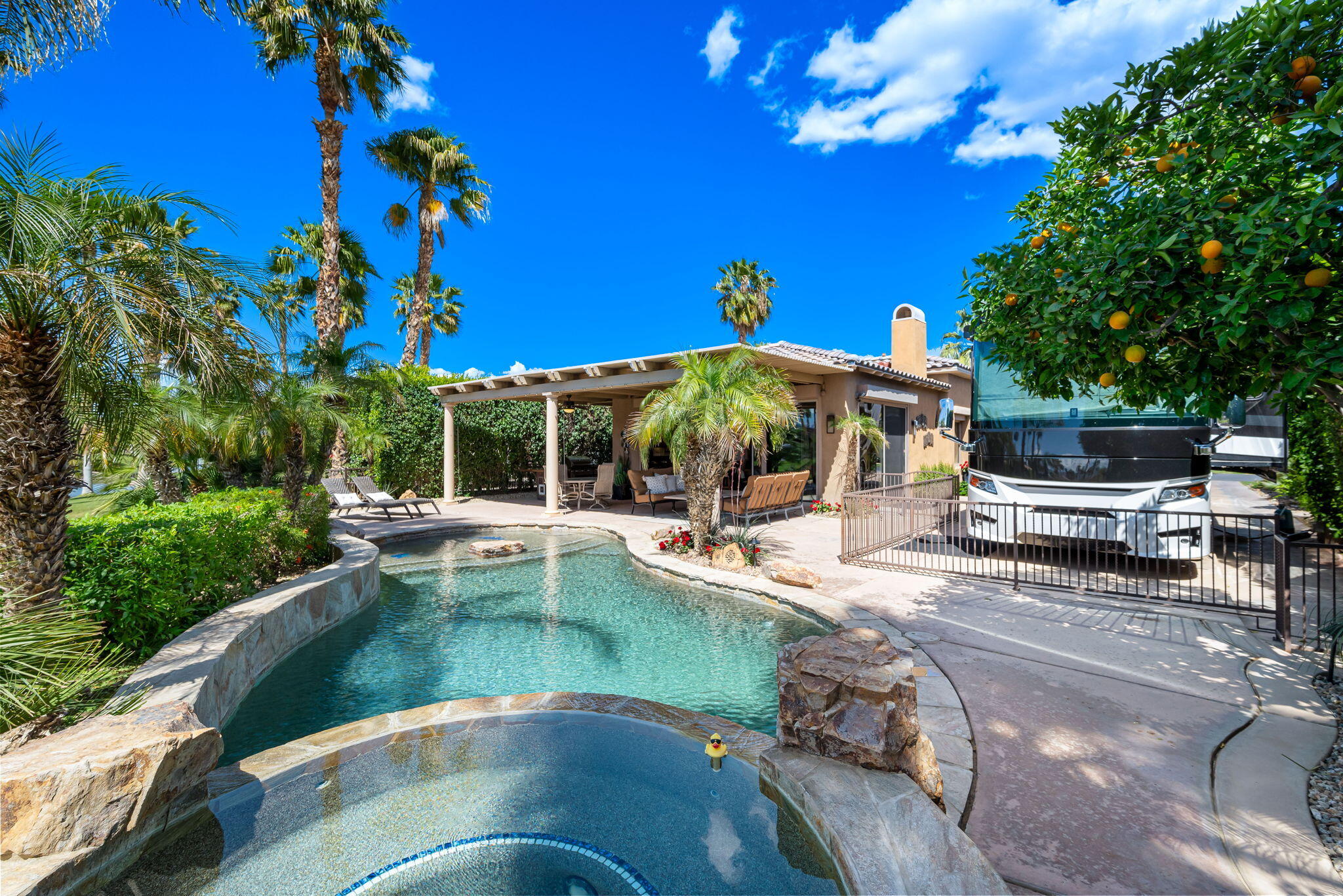 48170 Hjorth Street, Unit 74 Indio, CA 92201 - Photo 21 of 37 a view of a swimming pool with chairs