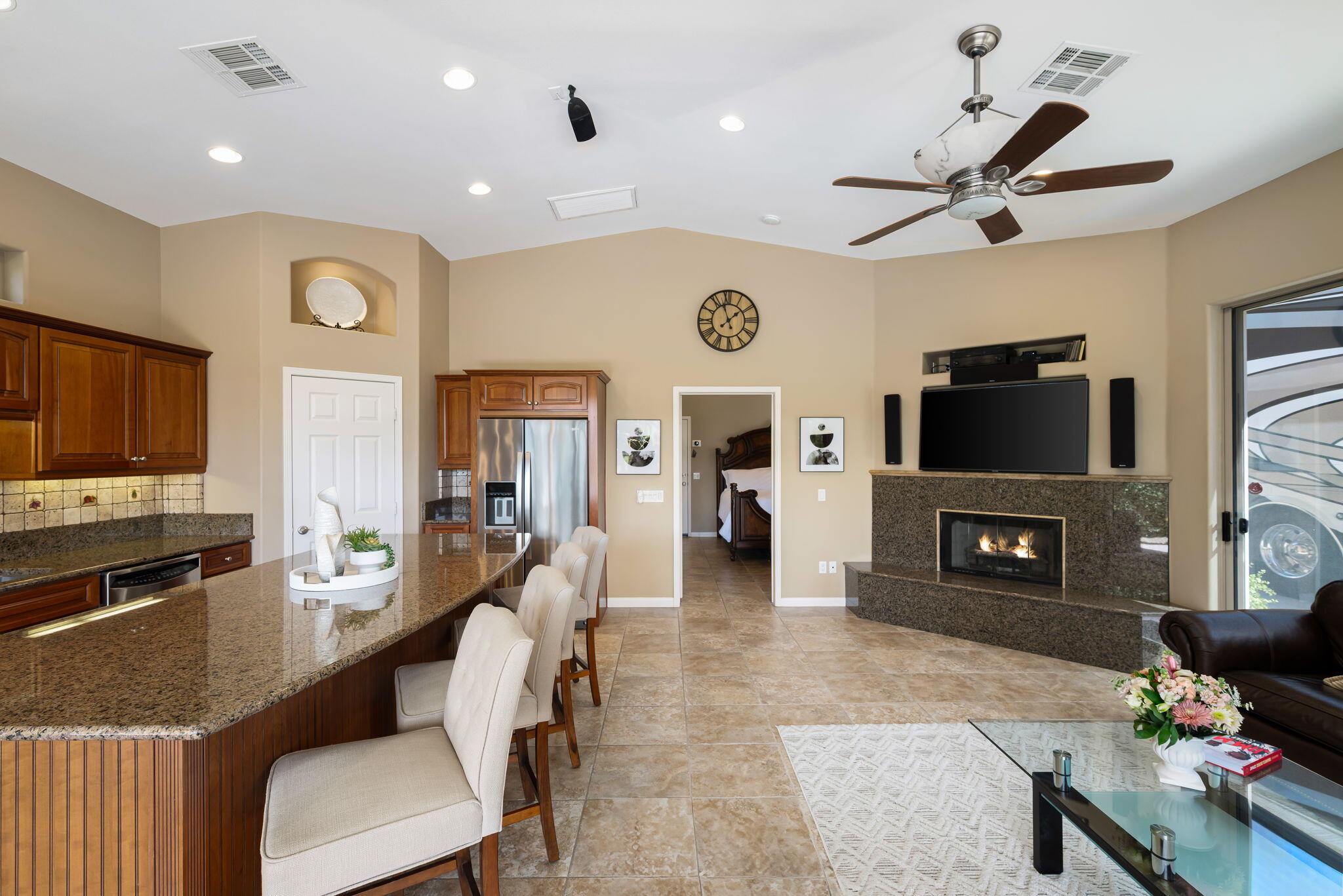 48170 Hjorth Street, Unit 74 Indio, CA 92201 - Photo 22 of 37 a living room with furniture a flat screen tv and a fireplace