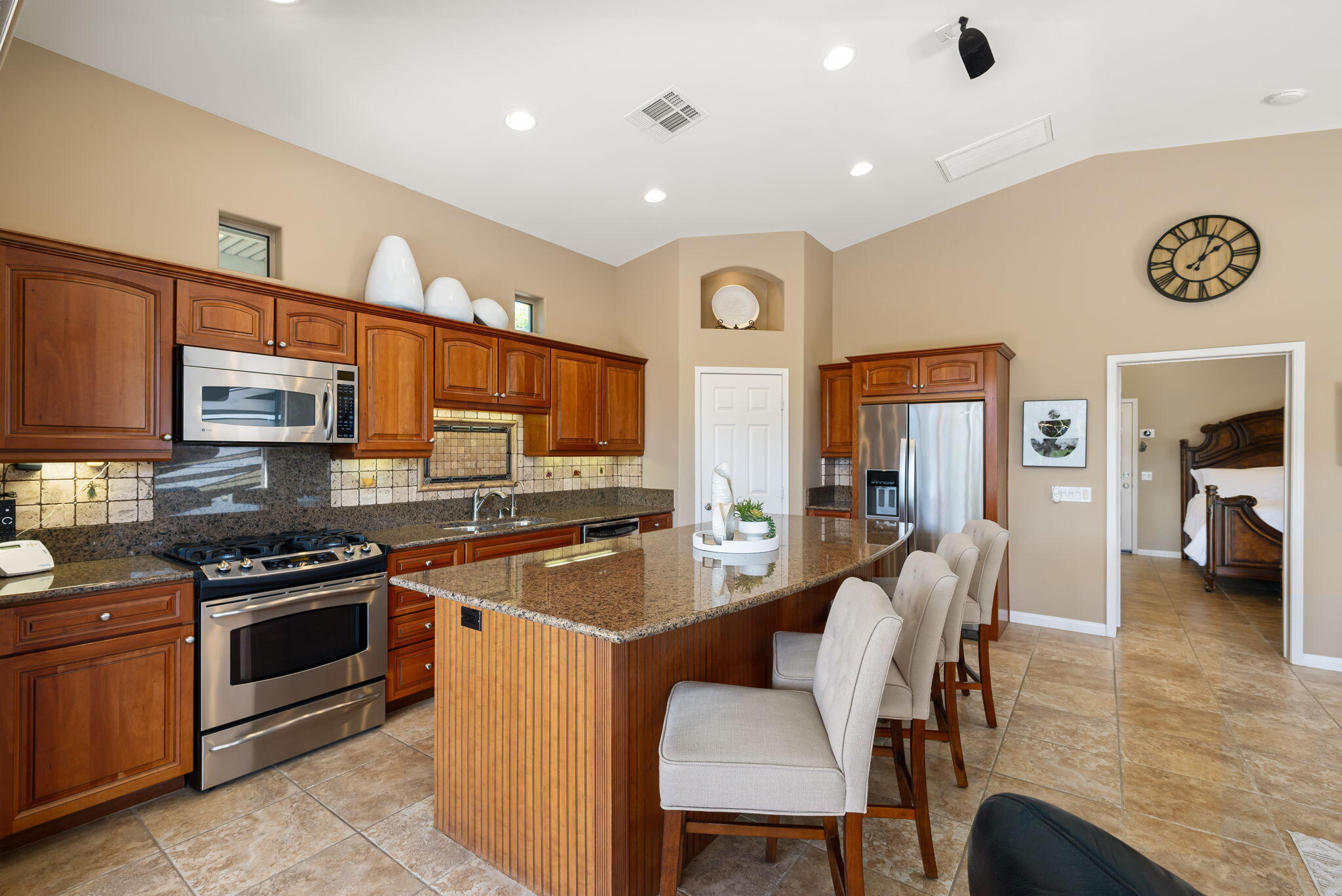 48170 Hjorth Street, Unit 74 Indio, CA 92201 - Photo 29 of 37 a kitchen with a table chairs microwave and cabinets