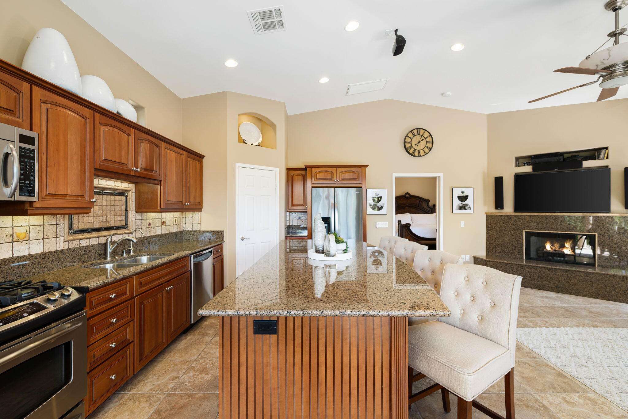 48170 Hjorth Street, Unit 74 Indio, CA 92201 - Photo 30 of 37 a kitchen with stainless steel appliances granite countertop a stove top oven a sink dishwasher and cabinets with wooden floor