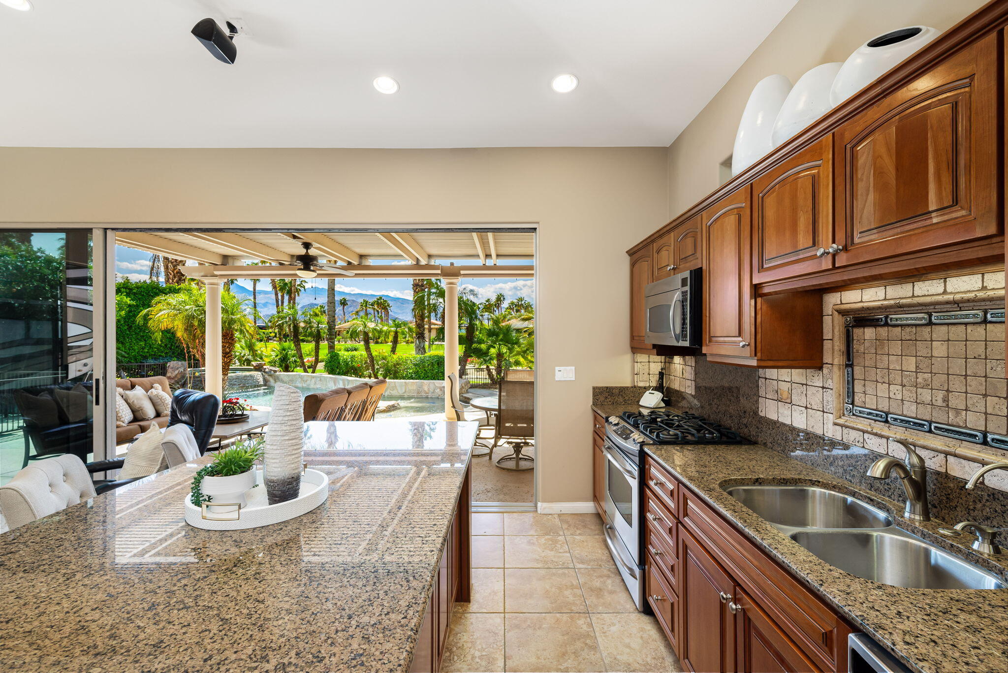 48170 Hjorth Street, Unit 74 Indio, CA 92201 - Photo 32 of 37 a kitchen with a sink and a stove top oven