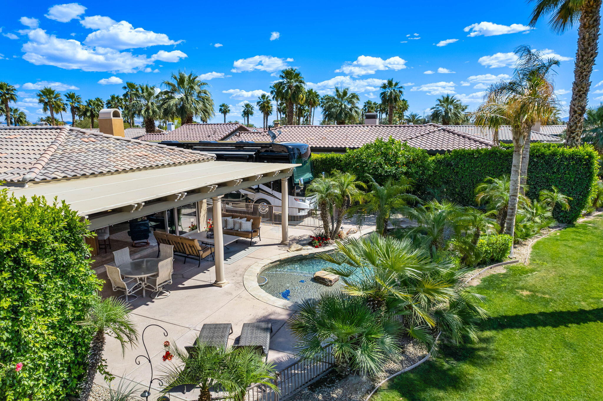 48170 Hjorth Street, Unit 74 Indio, CA 92201 - Photo 4 of 37 a view of a patio with table and chairs and potted plants