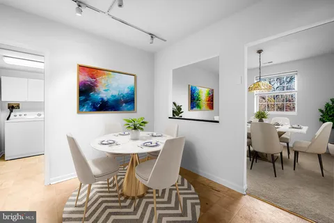 a view of an empty room with window and chandelier fan