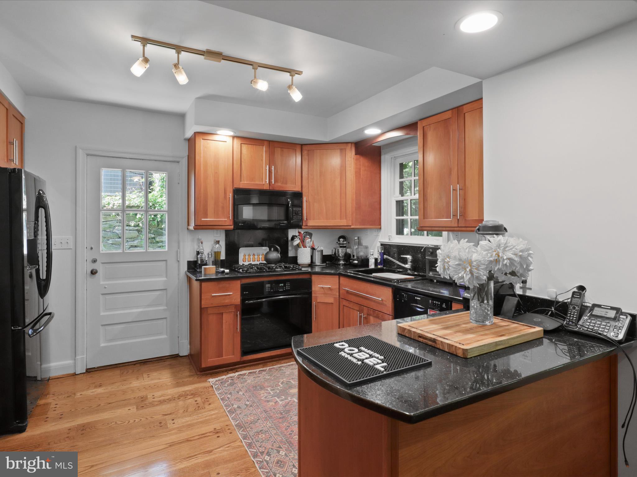 4725 Rock Spring Road Arlington, VA 22207 - Photo 13 of 59 a kitchen with kitchen island granite countertop a stove cabinets and refrigerator