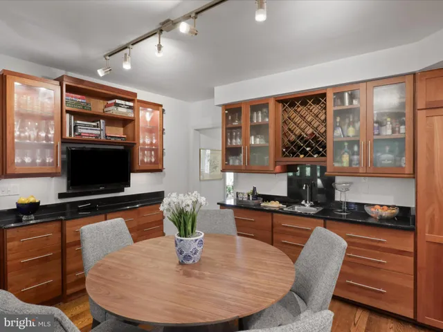 a living room with furniture a large window and a flat screen tv