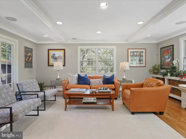 a living room with furniture and a pool table