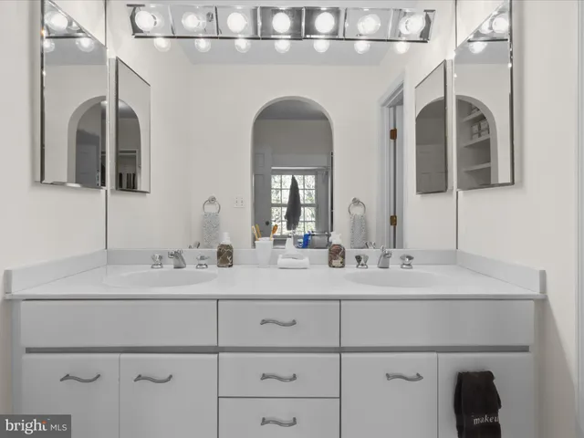 a bathroom with a double vanity sink and a mirror