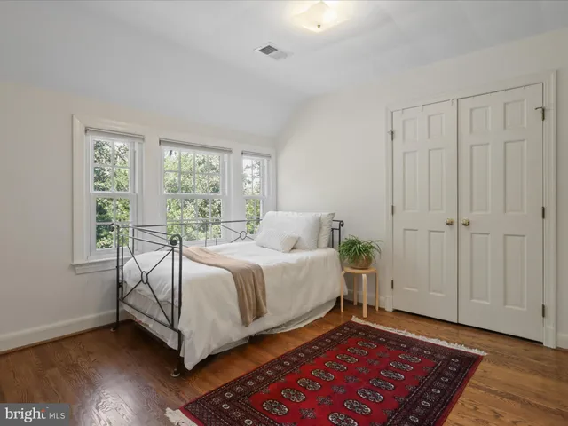 a bed room with a bed and a window