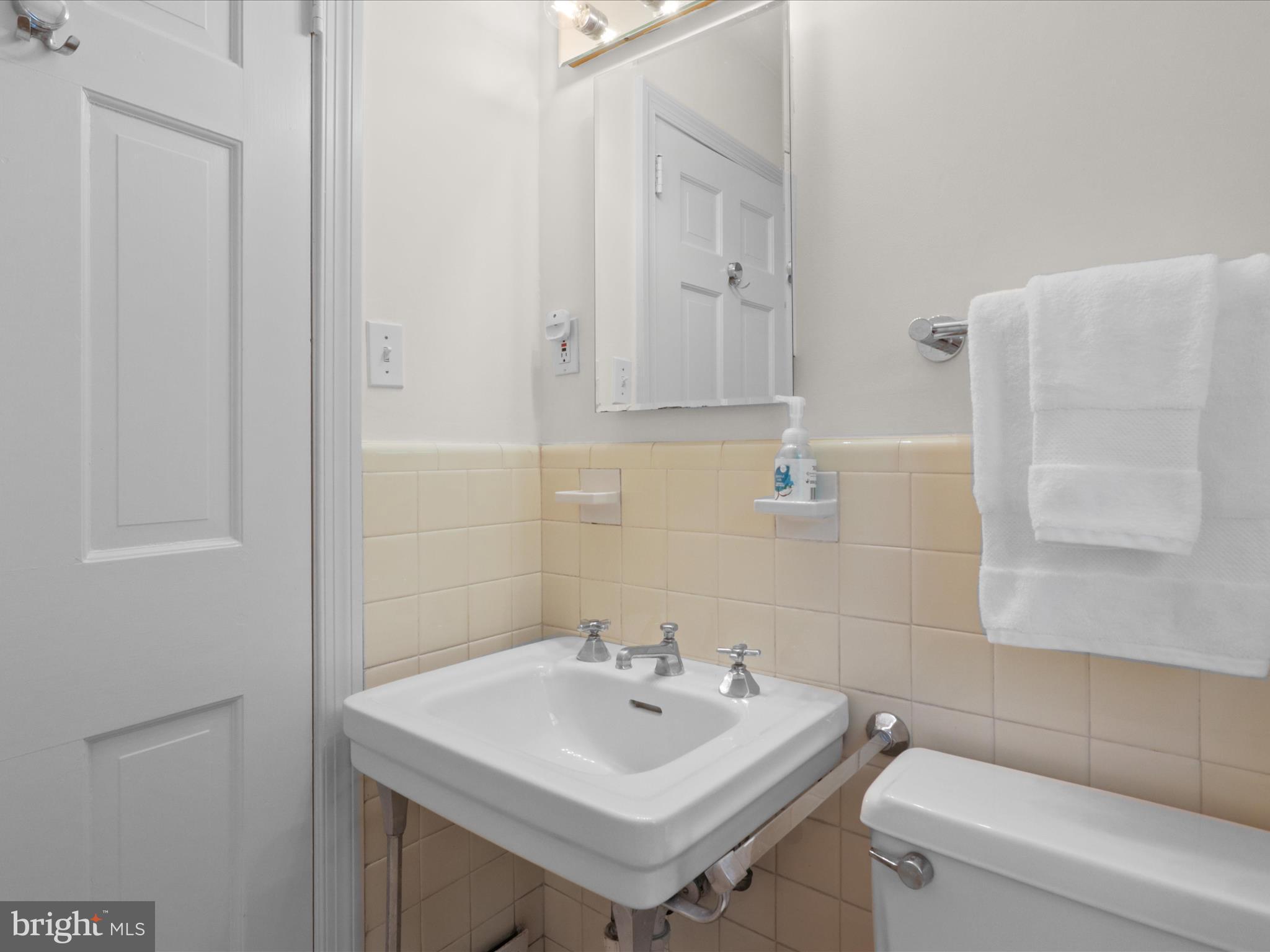 4725 Rock Spring Road Arlington, VA 22207 - Photo 33 of 59 a bathroom with a sink a toilet and a mirror