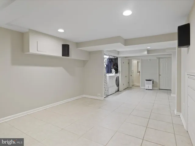 a bedroom with two beds and a flat screen tv