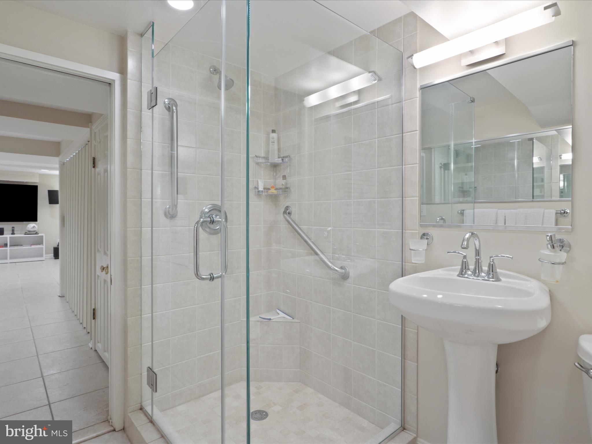 4725 Rock Spring Road Arlington, VA 22207 - Photo 37 of 59 a bathroom with a sink a mirror and shower