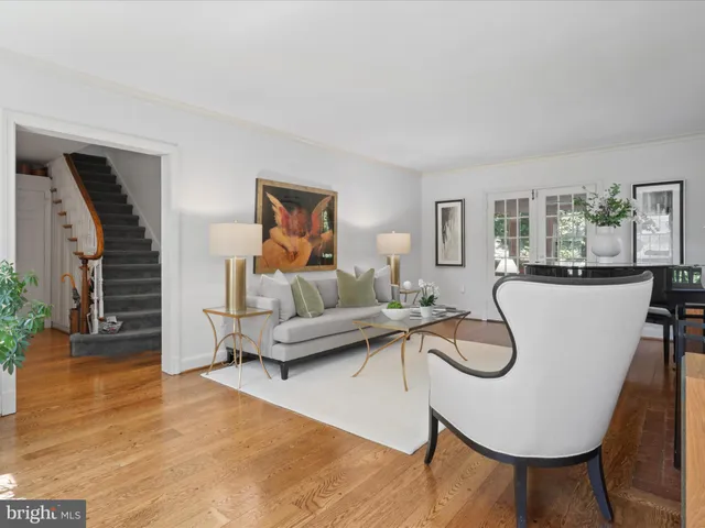 a living room with furniture a couch and potted plant