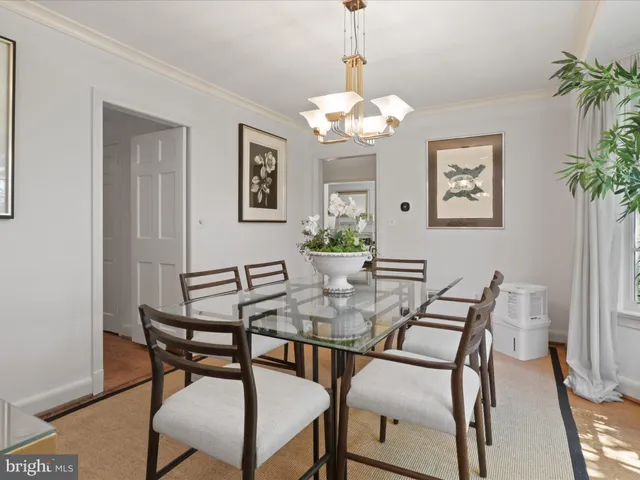 a view of a dining room with furniture wooden floor and a chandelier