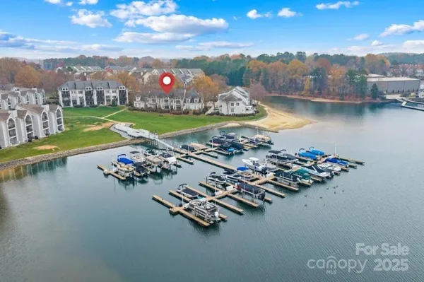 an aerial view of a house with a garden and lake view