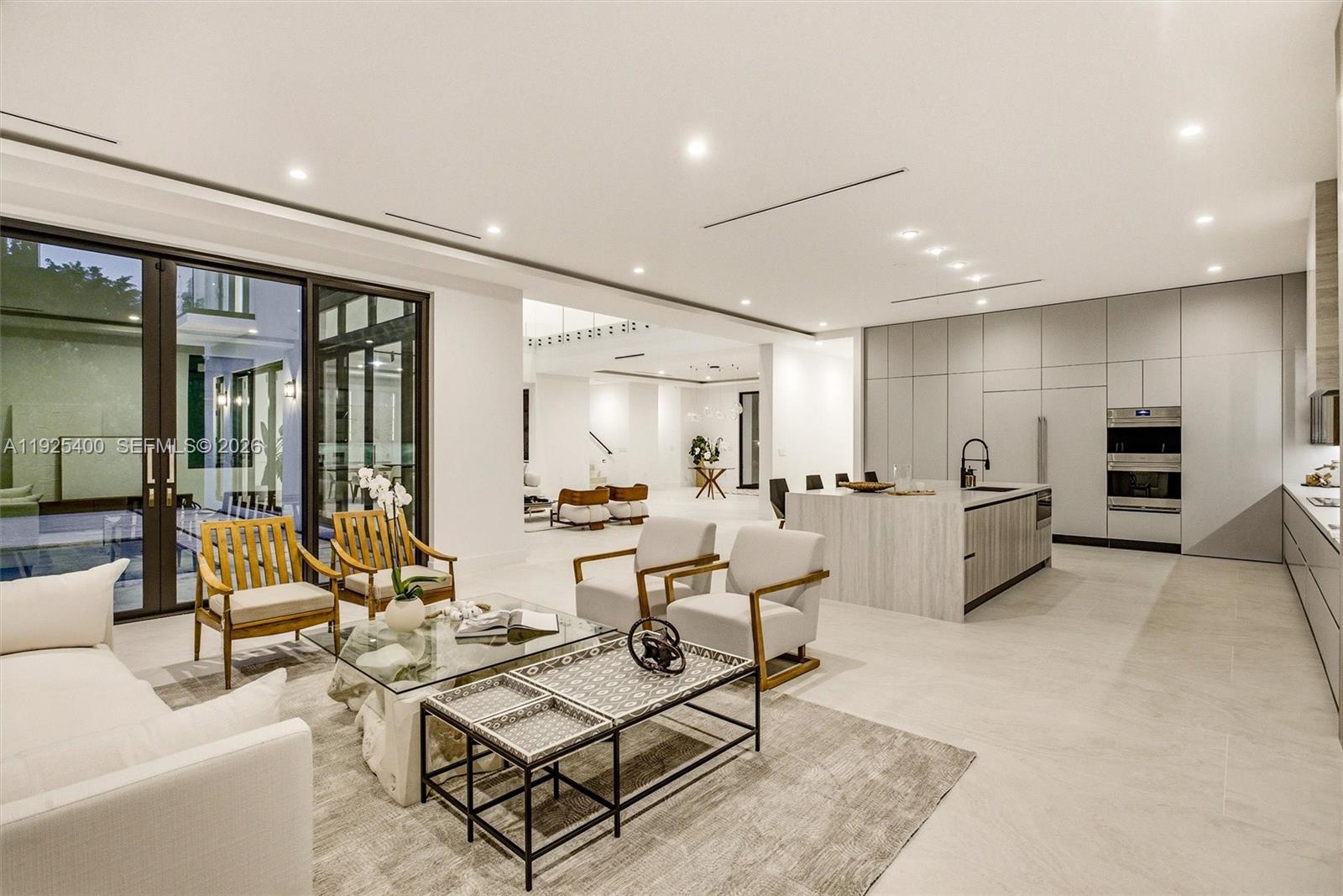 9840 Southwest 73rd Court Pinecrest, FL 33156 - Photo 28 of 67 Chef's Kitchen & Family Room | Open Plan | Island | Floor-to-Ceiling Glass