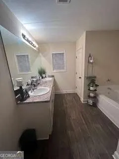 a bathroom with a sink a toilet and mirror