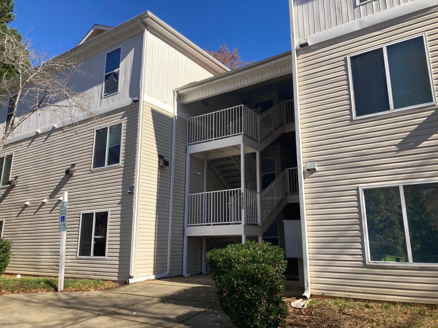 1501 Graduate Lane, Unit 103 Raleigh, NC 27606 - Photo 2 of 9 a view of the house with more windows and brick walls