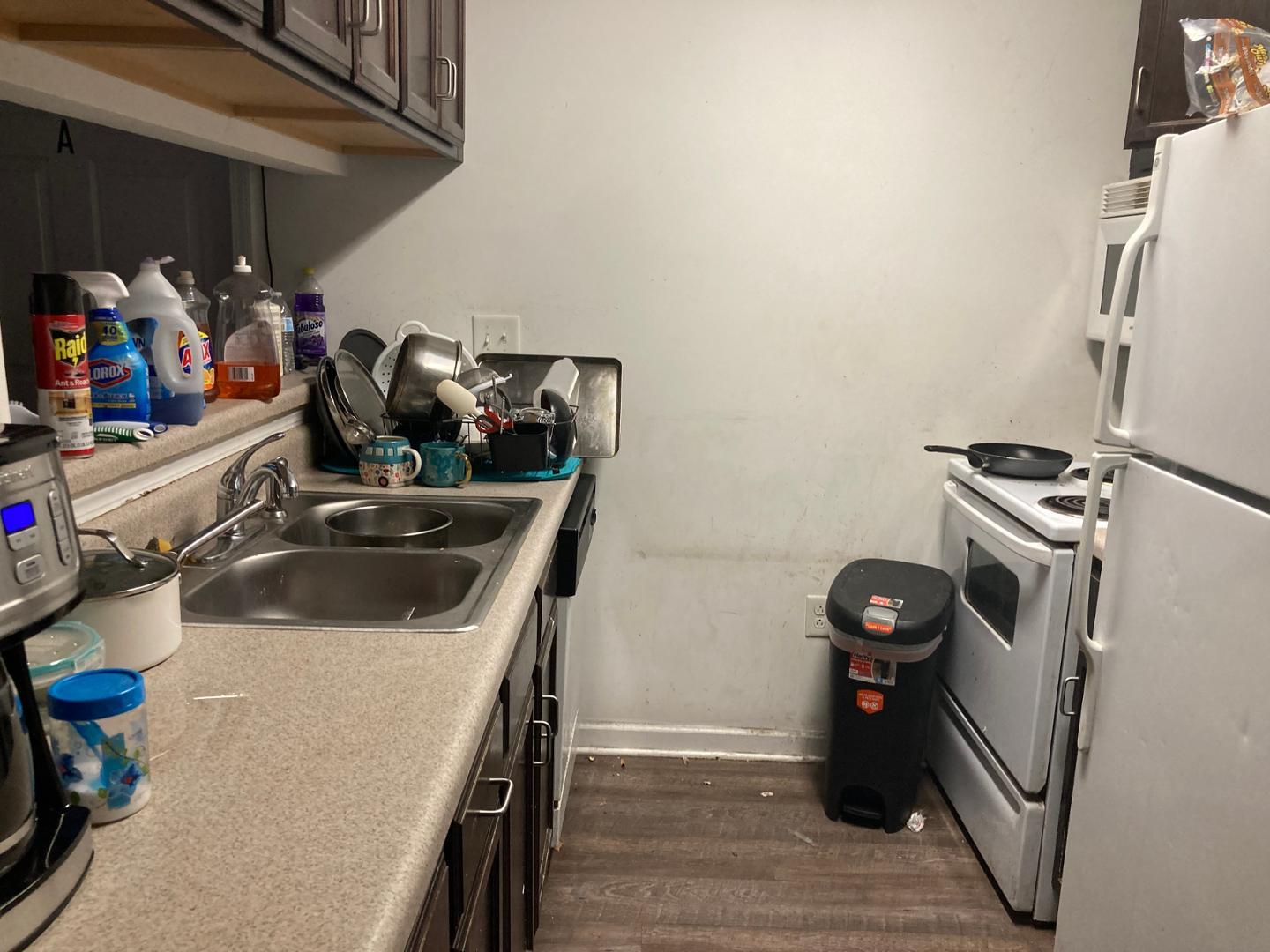 1501 Graduate Lane, Unit 103 Raleigh, NC 27606 - Photo 5 of 9 a kitchen with a sink and a stove top oven