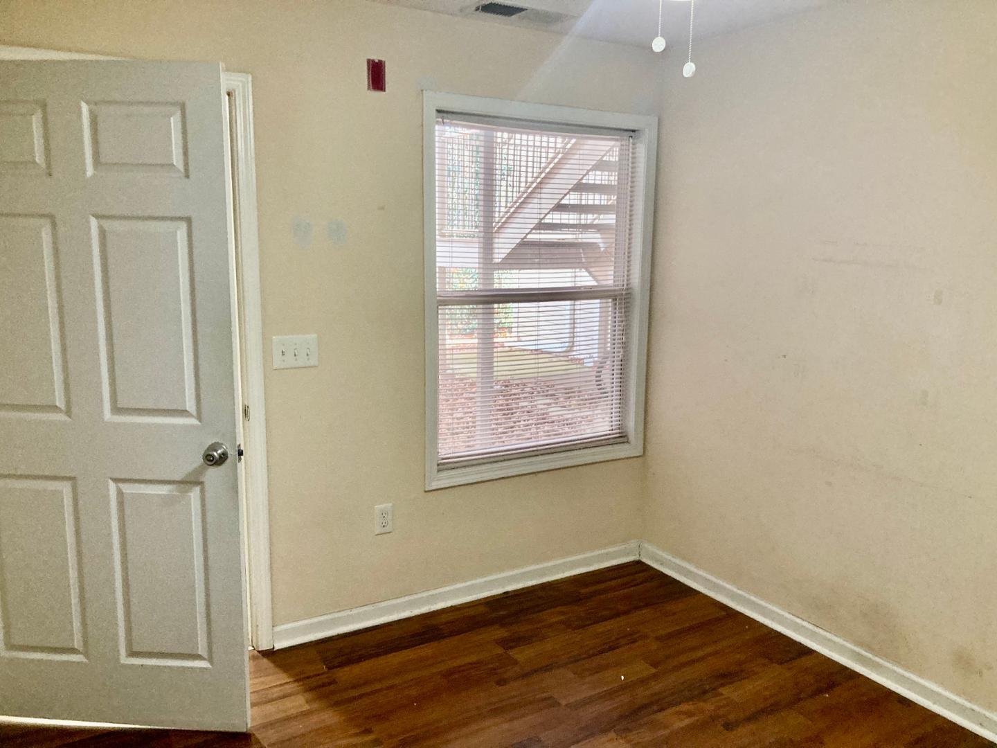 1501 Graduate Lane, Unit 103 Raleigh, NC 27606 - Photo 8 of 9 an empty room with wooden floor closet and windows