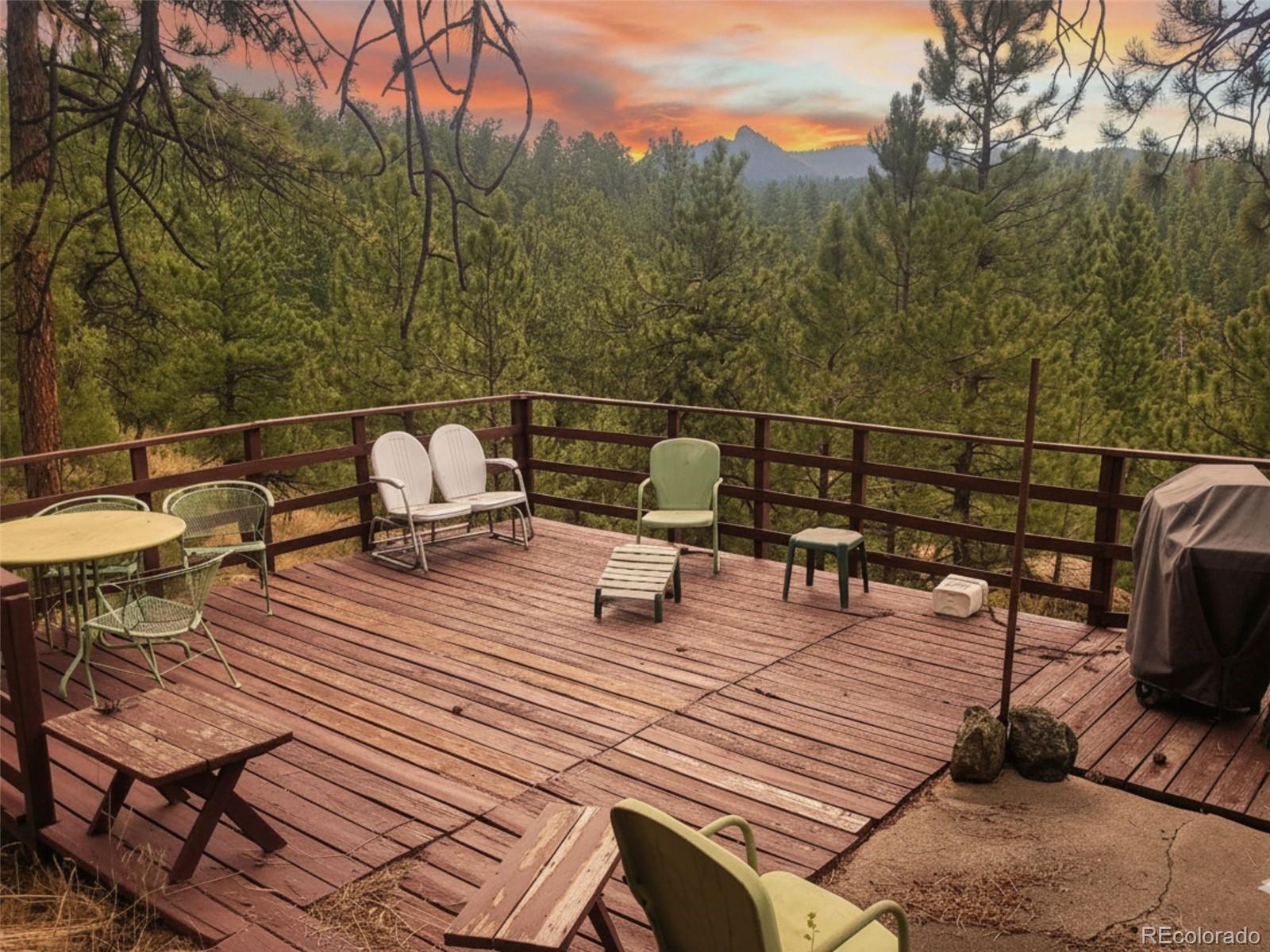 5162 South Rd A Evergreen, CO 80439 - Photo 11 of 26 a view of a roof deck with chair and wooden floor