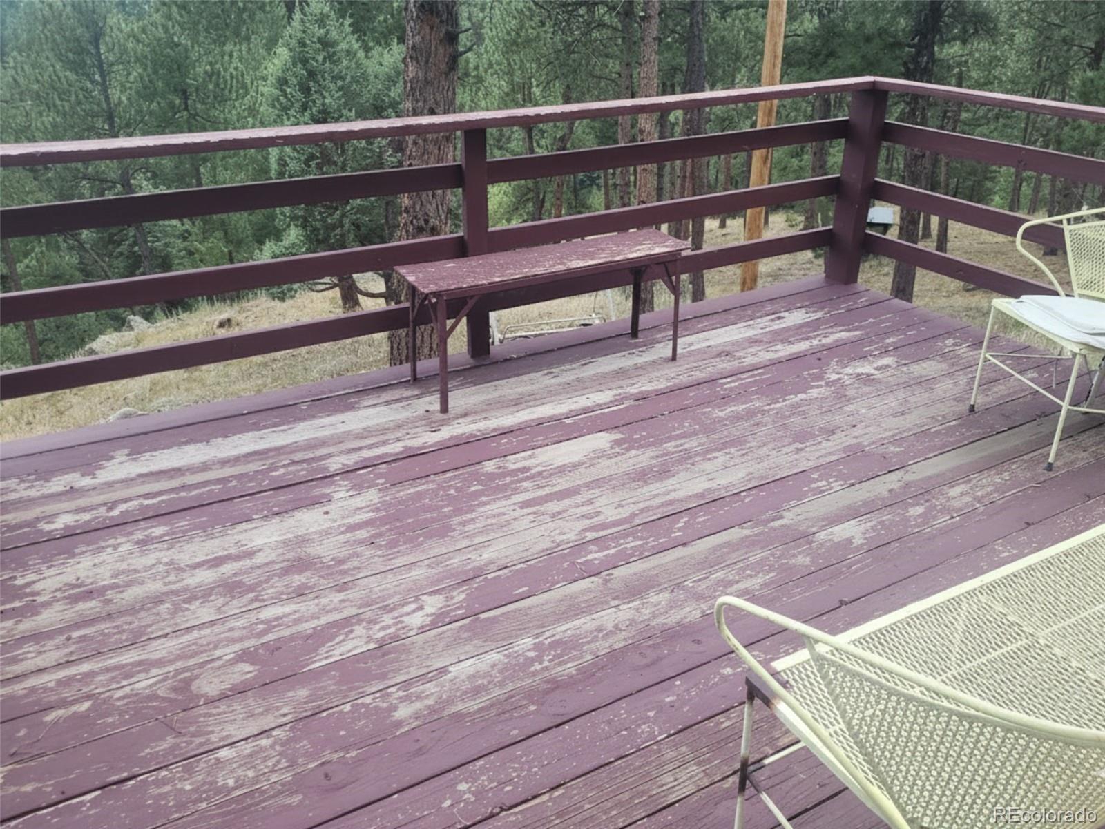 5162 South Rd A Evergreen, CO 80439 - Photo 12 of 26 a view of a chair and table on the wooden floor