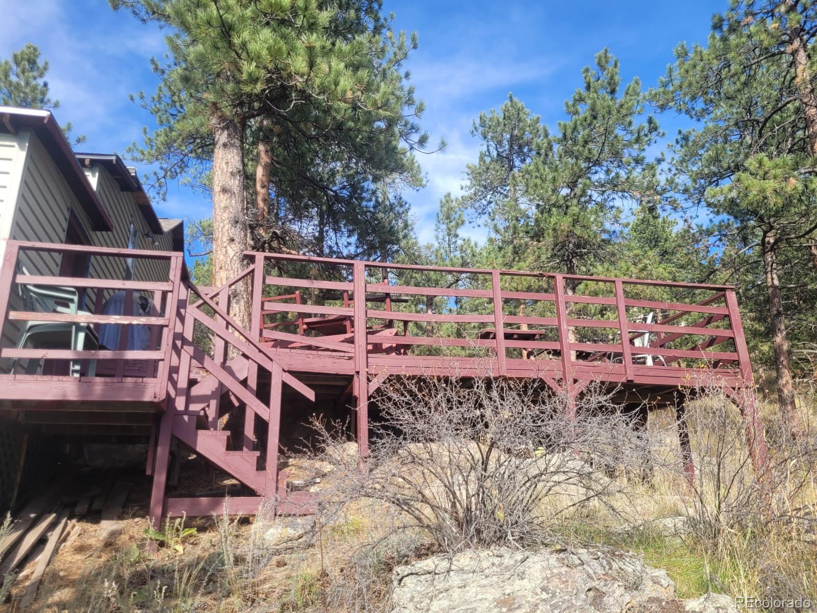 5162 South Rd A Evergreen, CO 80439 - Photo 16 of 26 a view of a chairs and tables in the backyard