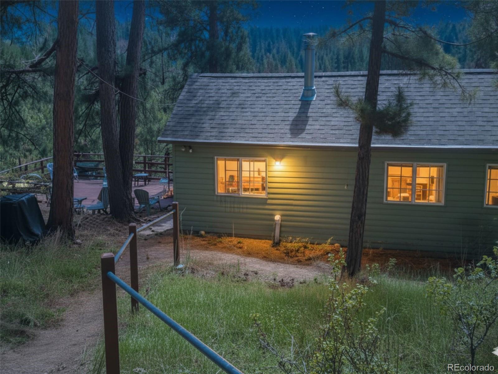 5162 South Rd A Evergreen, CO 80439 - Photo 2 of 26 a view of a backyard with plants and patio