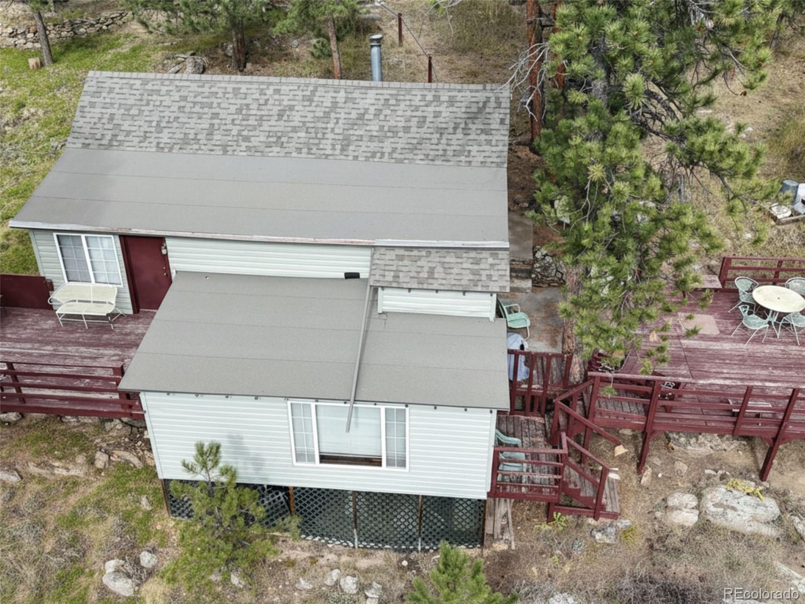 5162 South Rd A Evergreen, CO 80439 - Photo 24 of 26 an aerial view of a house with swimming pool