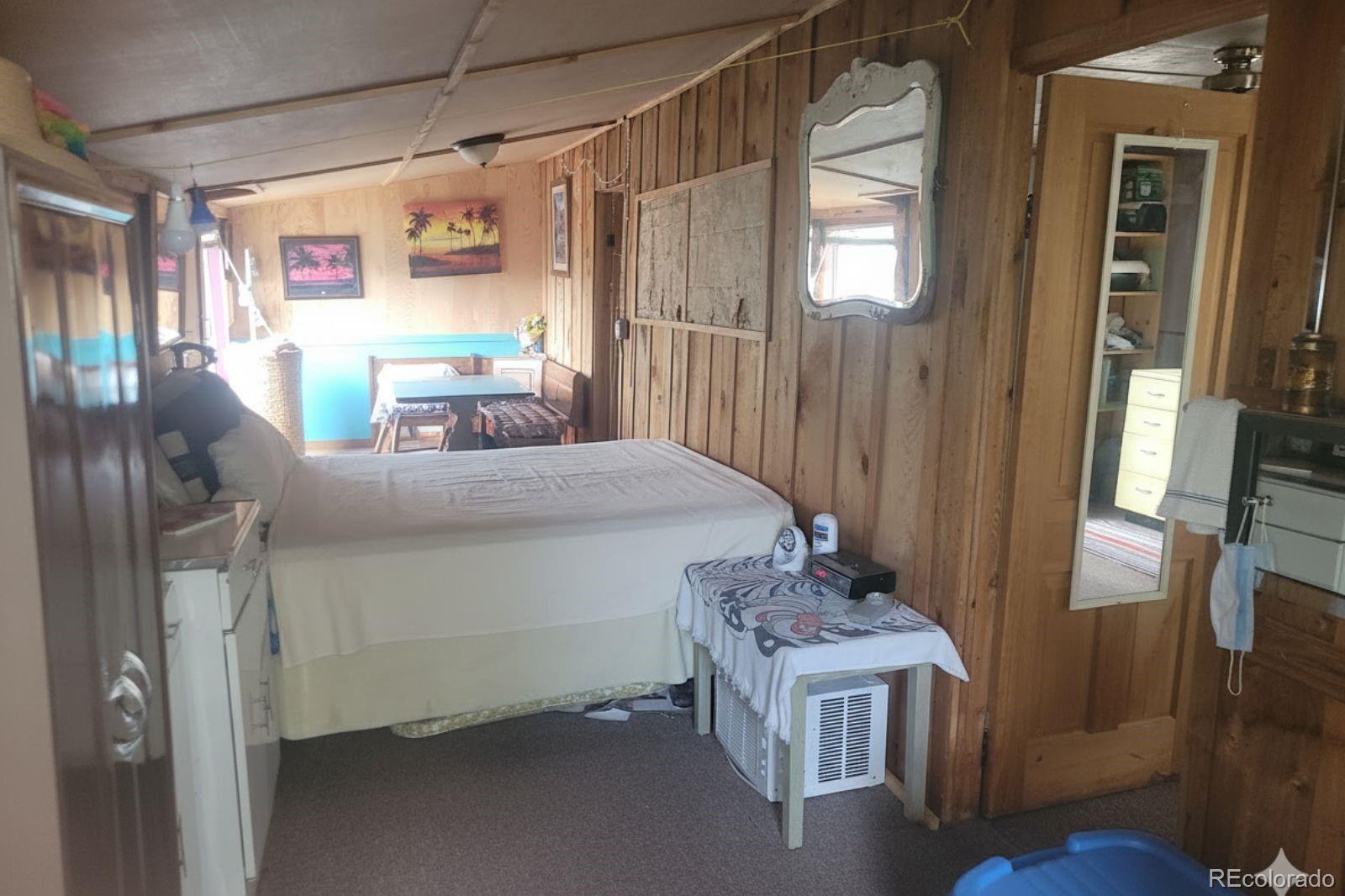 5162 South Rd A Evergreen, CO 80439 - Photo 6 of 26 a bedroom with a bed and a table in it