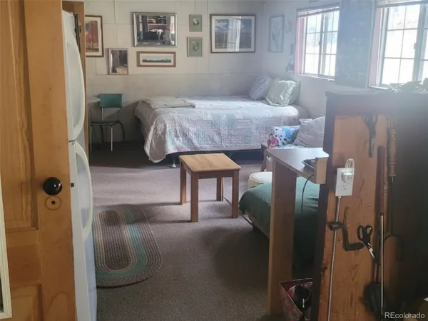 a bedroom with a bed and a painting on the wall