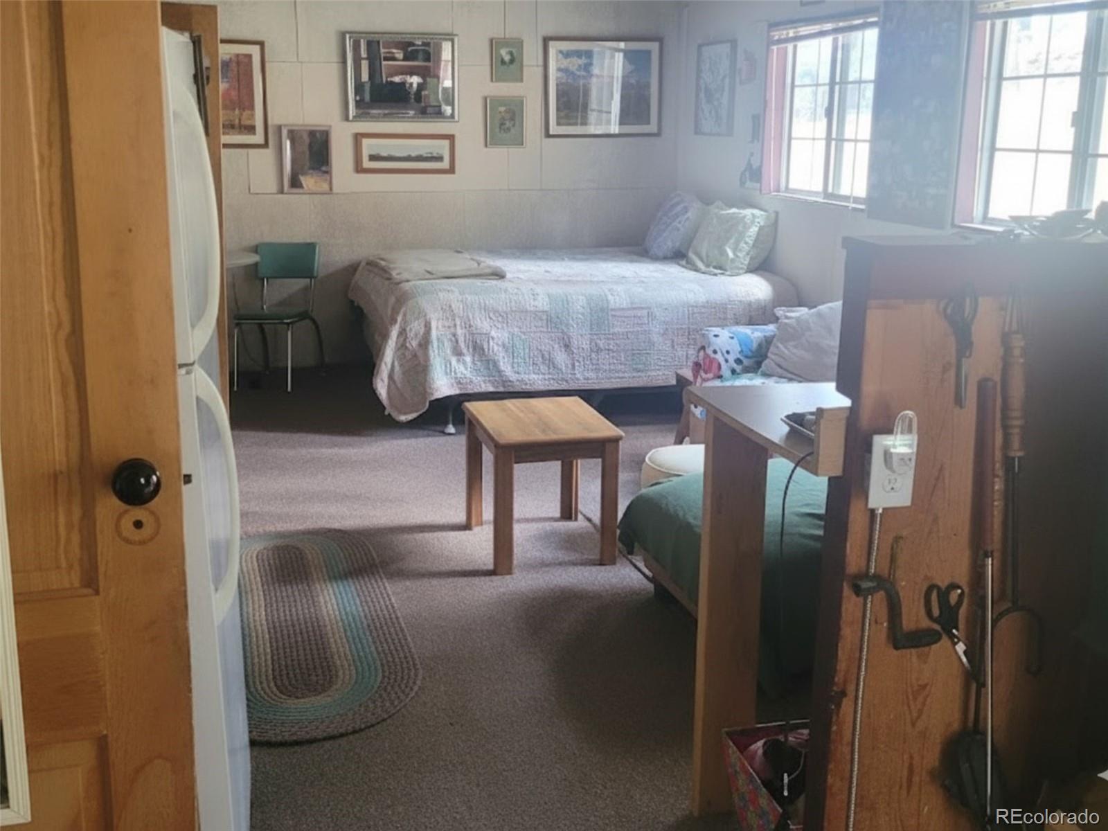 5162 South Rd A Evergreen, CO 80439 - Photo 7 of 26 a bedroom with a bed and a painting on the wall