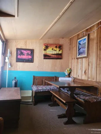 a room with furniture pool table and wall paintings
