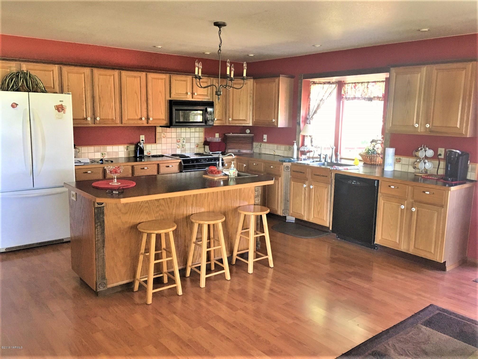 2060 Liberty Road Granger, WA 98932 - Photo 15 of 25 a kitchen with stainless steel appliances granite countertop a stove a sink a refrigerator a center island and a cabinets
