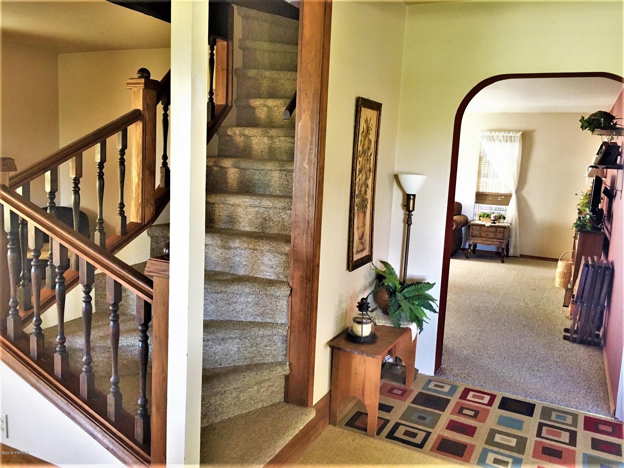 2060 Liberty Road Granger, WA 98932 - Photo 18 of 25 a view of staircase with wooden floor and mirror