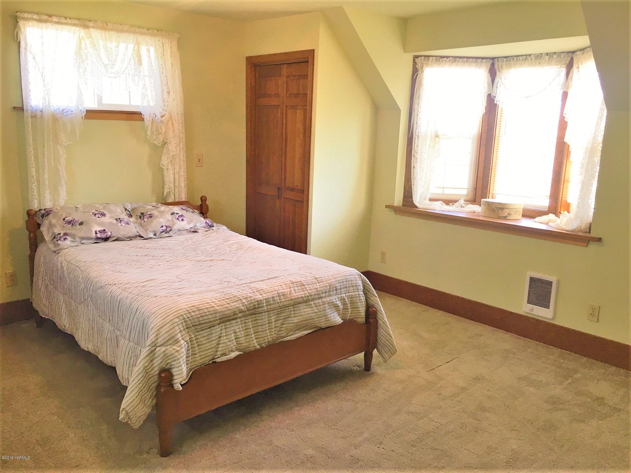 2060 Liberty Road Granger, WA 98932 - Photo 22 of 25 a bed sitting in a bathroom next to a window