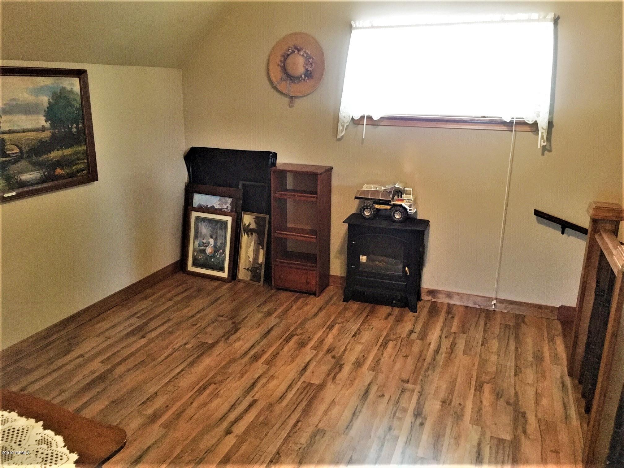 2060 Liberty Road Granger, WA 98932 - Photo 24 of 25 a living room with couch and a wooden floor