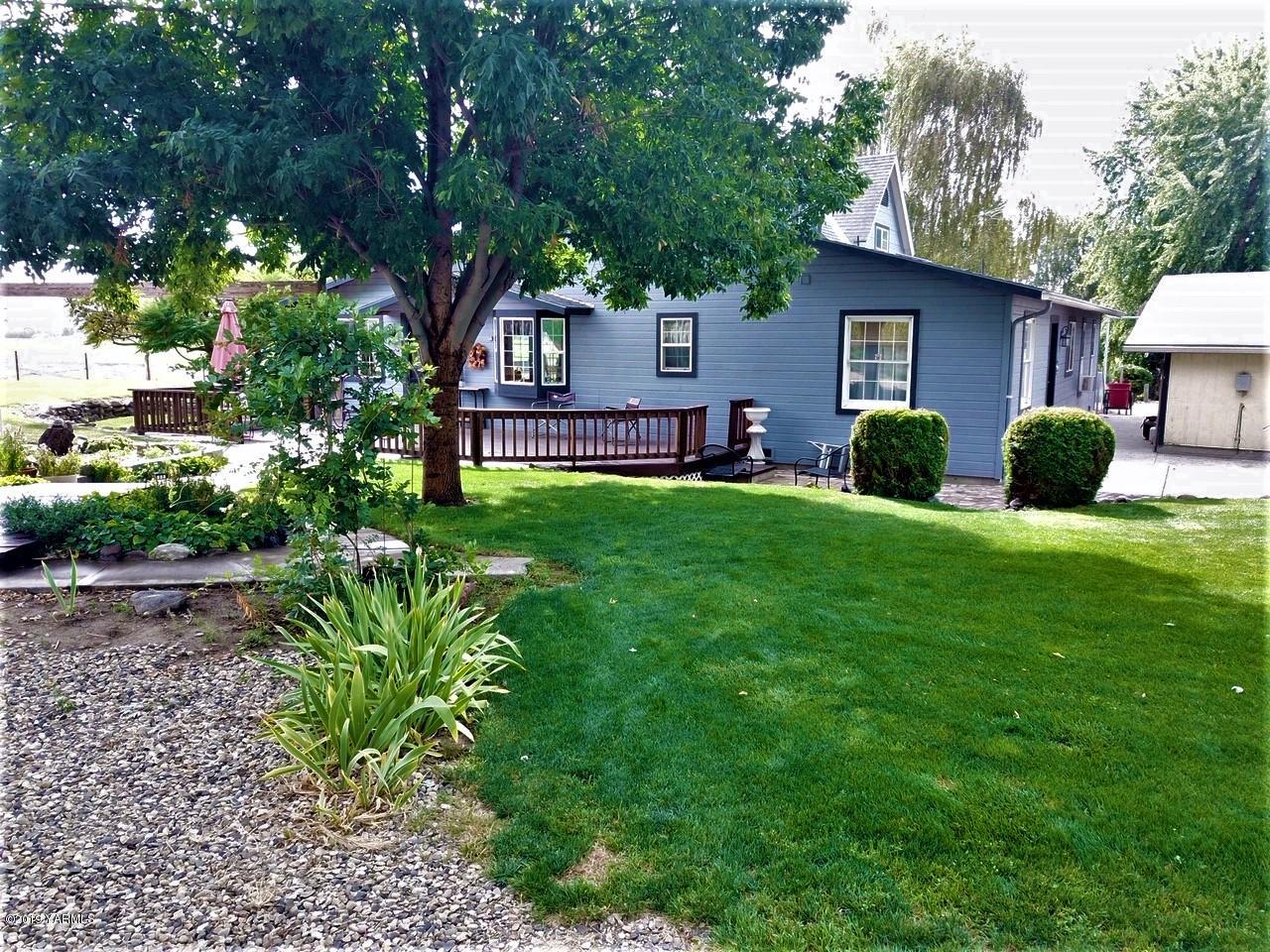2060 Liberty Road Granger, WA 98932 - Photo 5 of 25 a view of a house with a yard and a tree