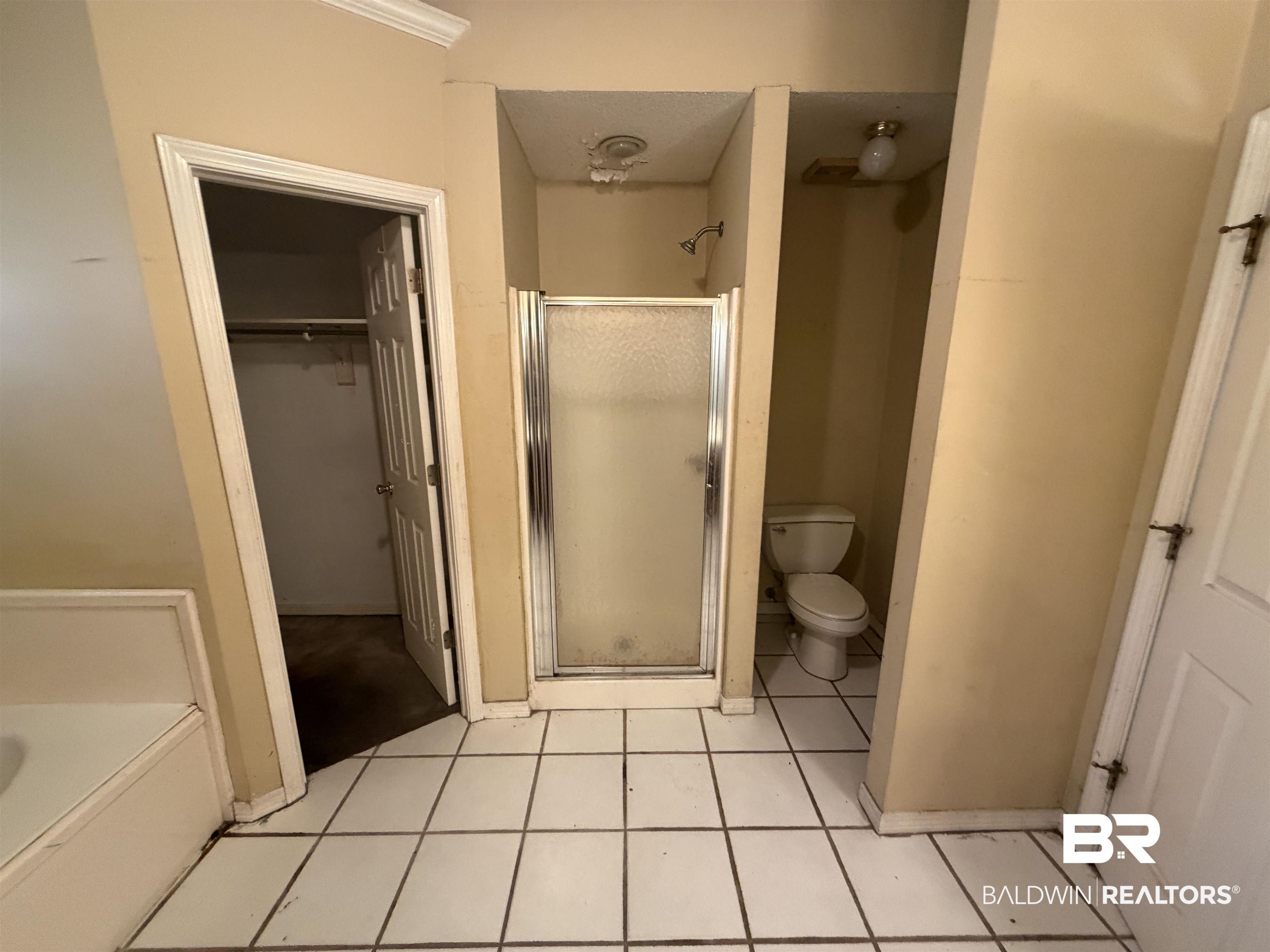7067 Pinehill Road Daphne, AL 36526 - Photo 17 of 18 Full bath featuring a shower stall, light tile patterned floors, a garden tub, and a walk in closet