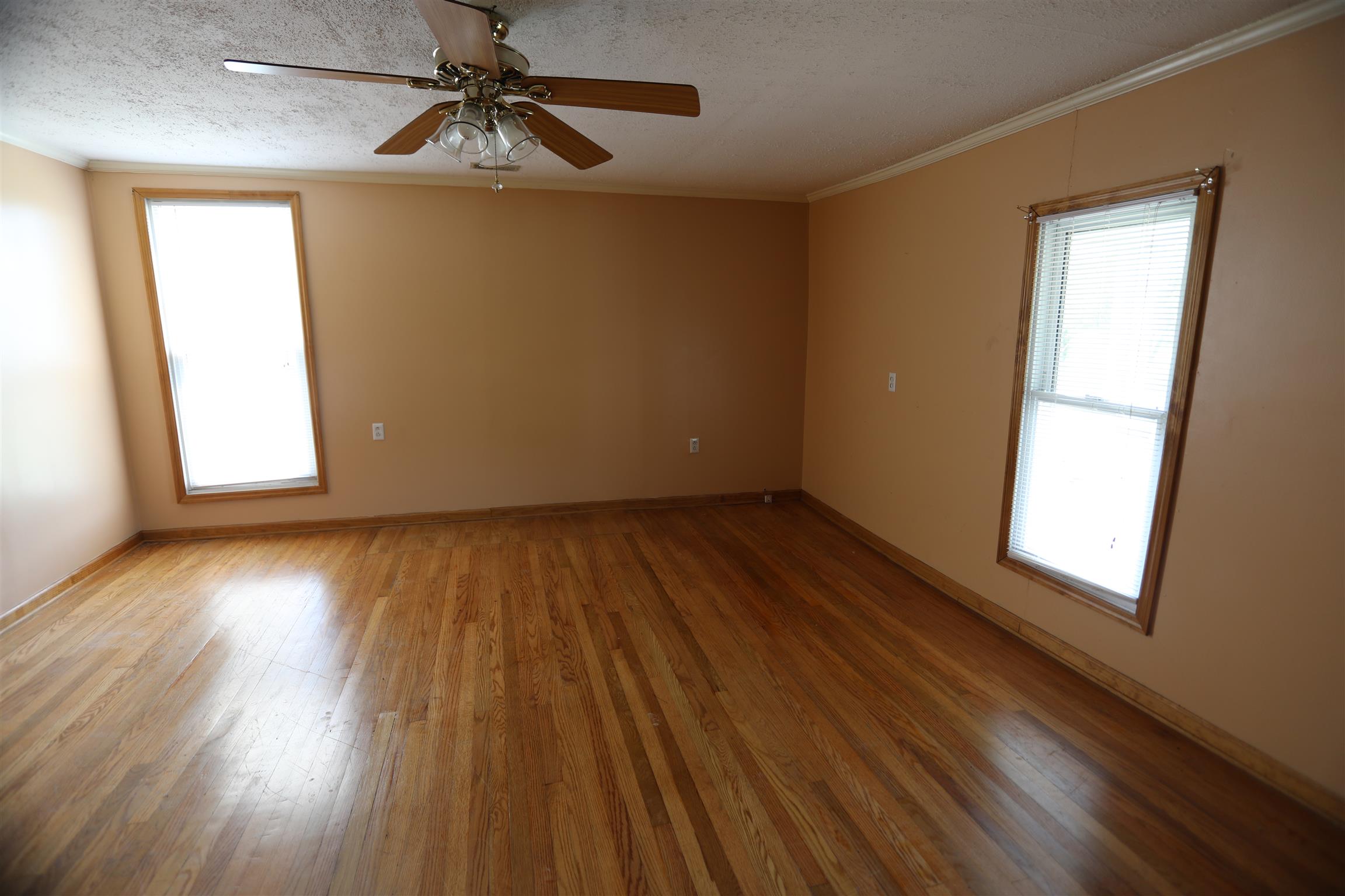 4651 Joe Peay Road Spring Hill, TN 37174 - Photo 12 of 28 an empty room with wooden floor chandelier fan and windows